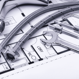 Background image showcasing a plumbing tools and a blueprint, representing the comprehensive plumbing services of Core Plumbing & Mechanical Ltd.